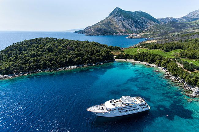Small cruise ship anchored in a clear Adriatic bay