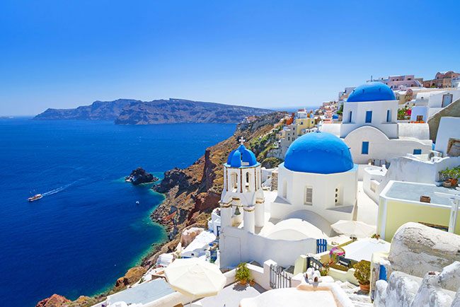 Blue domes and white houses above the sea in Santorini, Greece
