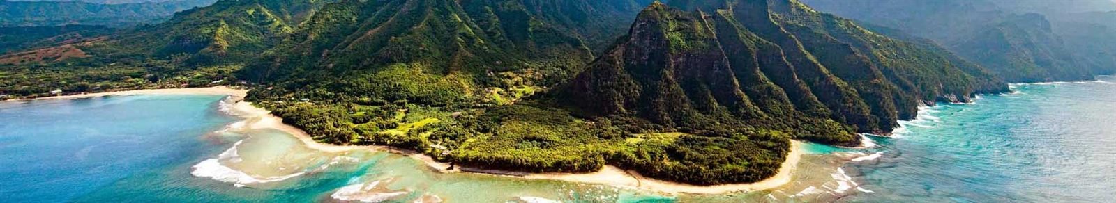 Green volcanic ridges dropping to the ocean in Hawaii